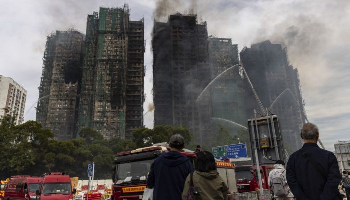 Pessoas-observam-predios-residenciais-atingidos-por-incendio-em-Hong-Kong.jpg