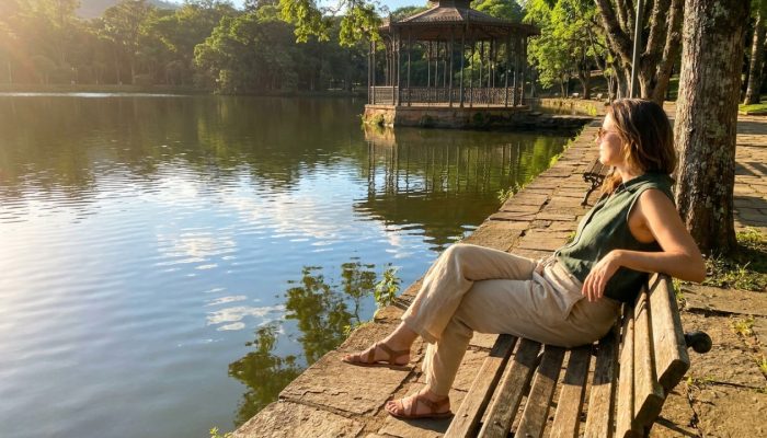 Woman_seated_on_bench_lake_202605161559.jpg
