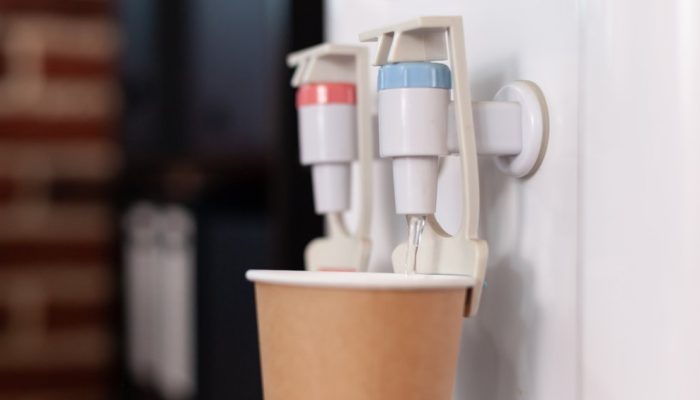 close-up-disposable-cup-water-cooler-startup-office-water-dispenser-with-hot-cold-faucet-used-refres.jpeg