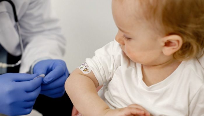 cropped-photo-boy-s-shoulder-with-stick-bandaid-vaccination.jpg