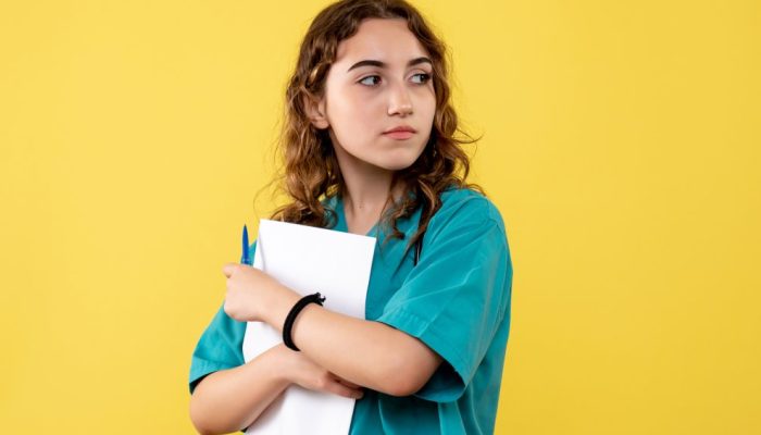 front-view-female-doctor-medical-shirt-holding-paper-analysis-virus-uniform-covid-19-health-pandemic.jpeg