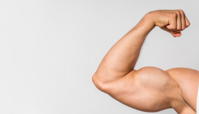 front-view-fit-man-showing-bicep-with-copy-space.jpg