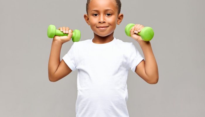 portrait-cheerful-afro-american-boy-with-skinny-arms-smiling-happily-while-exercising-gym-with-two-d.jpeg